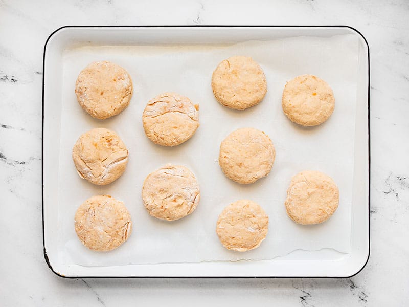 Sweet potato biscuits ready to bake on a parchment lined baking sheet