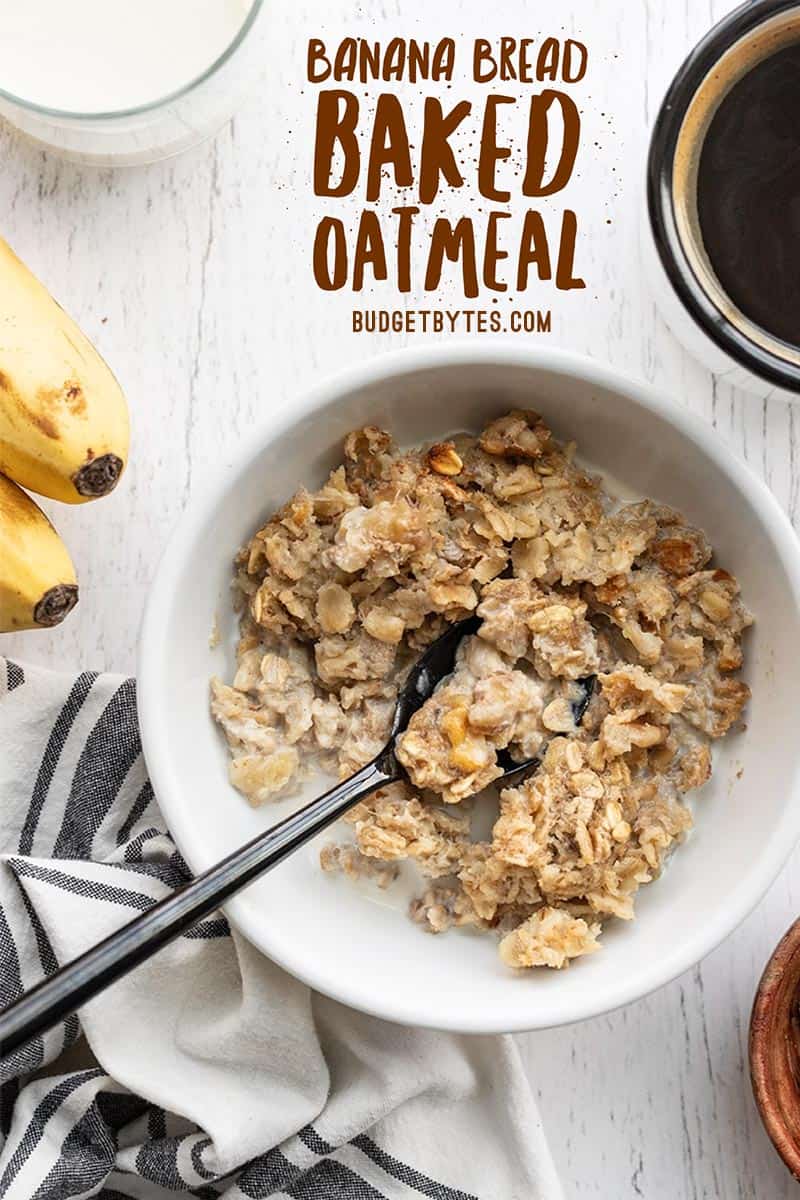 Overhead view of a bowl full of banana bread baked oatmeal with a spoon in the center, title text at the top