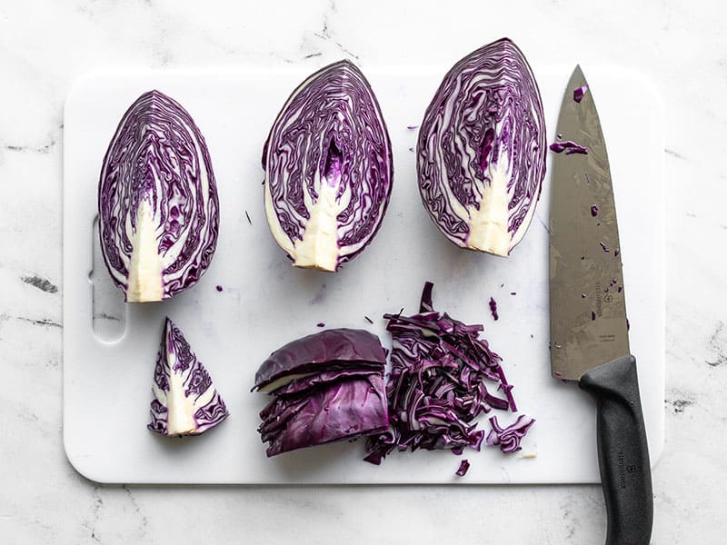 Purple cabbage cut into quarters and shredded