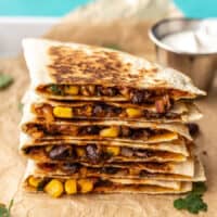 A stack of black bean quesadillas on a serving tray