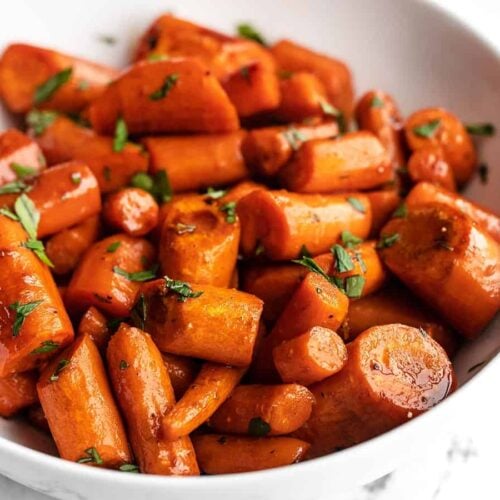 close up side view of a bowl of honey balsamic glazed carrots