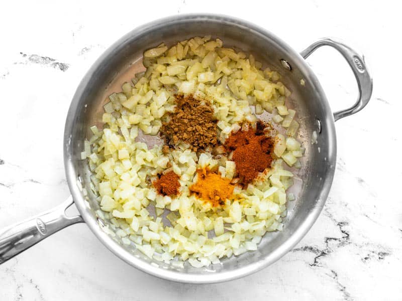 Spices added to skillet with onion garlic and ginger