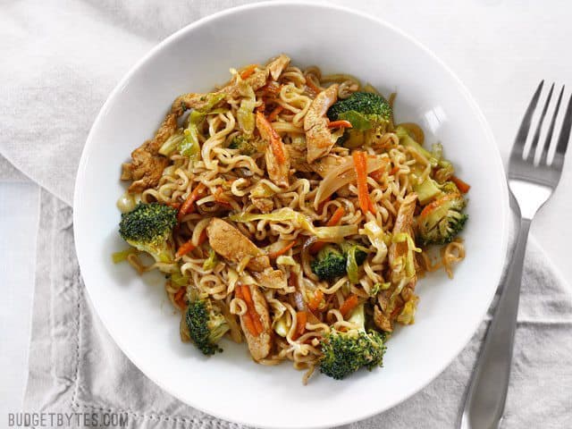 A finished bowl of Chicken Yakisoba with vegetables, fork on the side