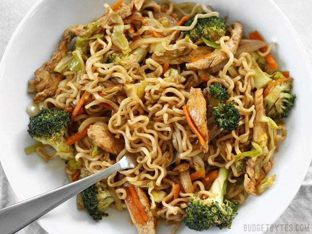 Close up view of a bowl of Chicken Yakisoba with vegetables.