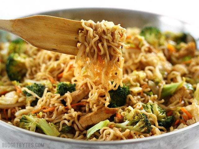 A pan full of Chicken Yakisoba with the noodles wound around the pasta fork.