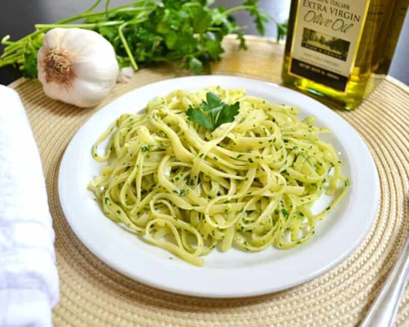 Parsley pesto  pasta on a white plate.