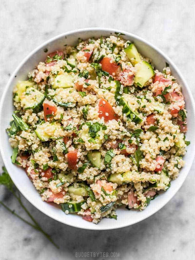 A big bowl of freshly made Quinoa Tabbouleh on a marble countertop 