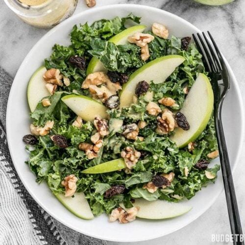 This Apple Dijon Kale Salad is tangy, sweet, and crunchy with Granny Smith apples, walnuts, raisins, and a homemade Dijon vinaigrette. BudgetBytes.com