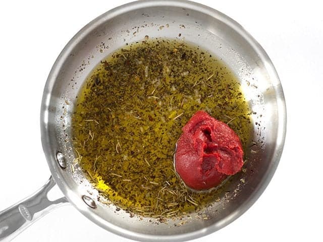 Add Tomato Paste and Honey to the skillet with oil and herbs