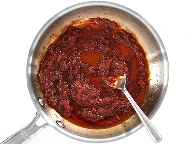Finished Not Sun Dried Tomato Sauce in the skillet with a spoon