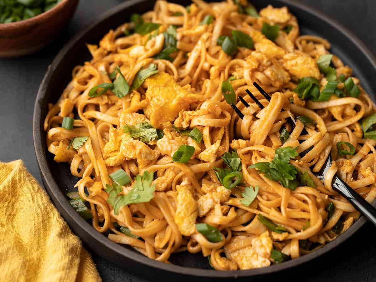 Close up side view of a plate of spicy sriracha noodles