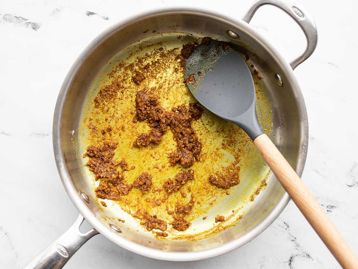 Spices added to the skillet with garlic and ginger