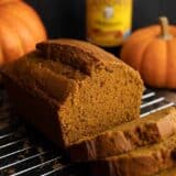 Side view of a sliced loaf of pumpkin molasses bread