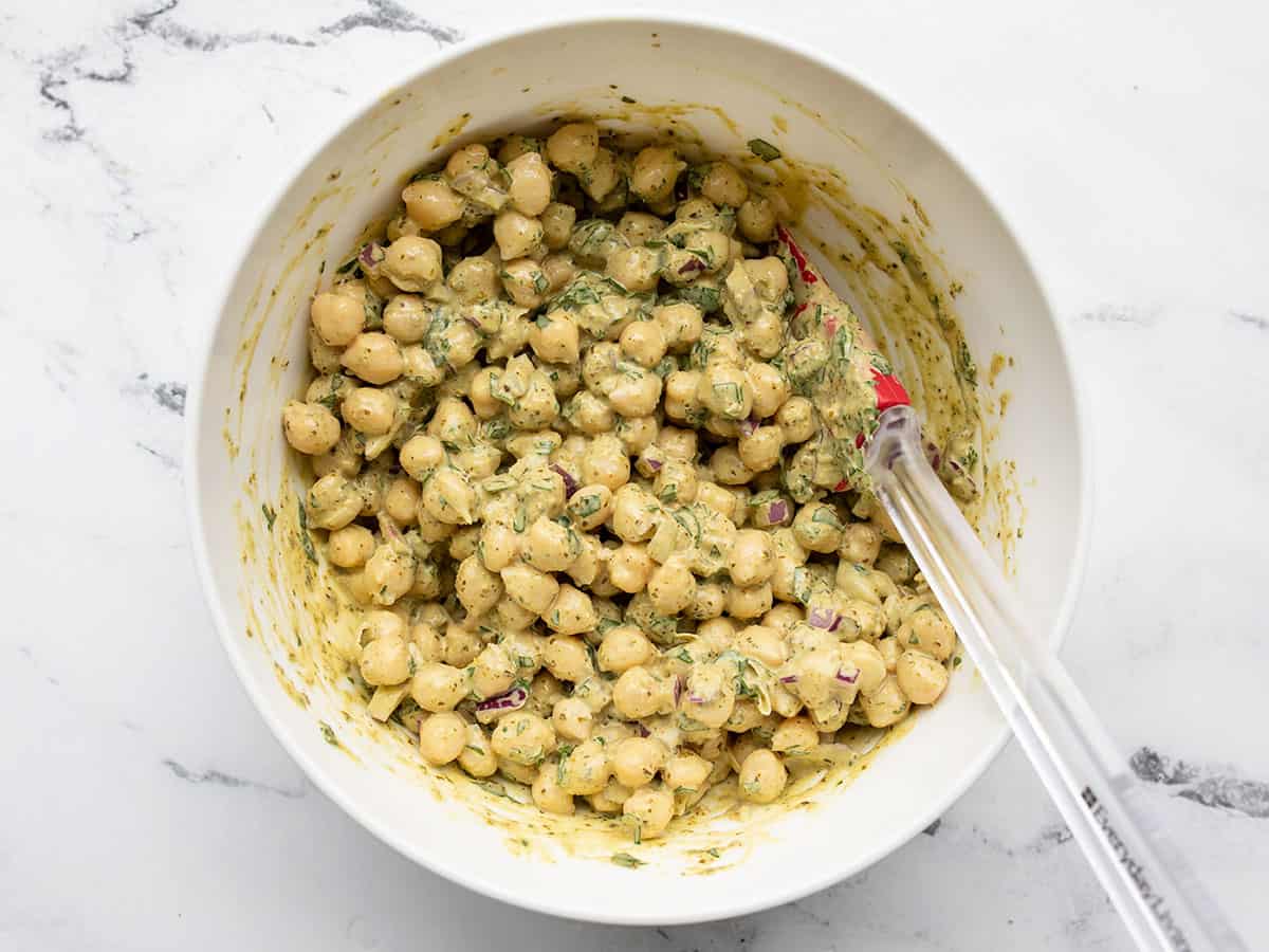 Dressing added to chickpeas in the bowl