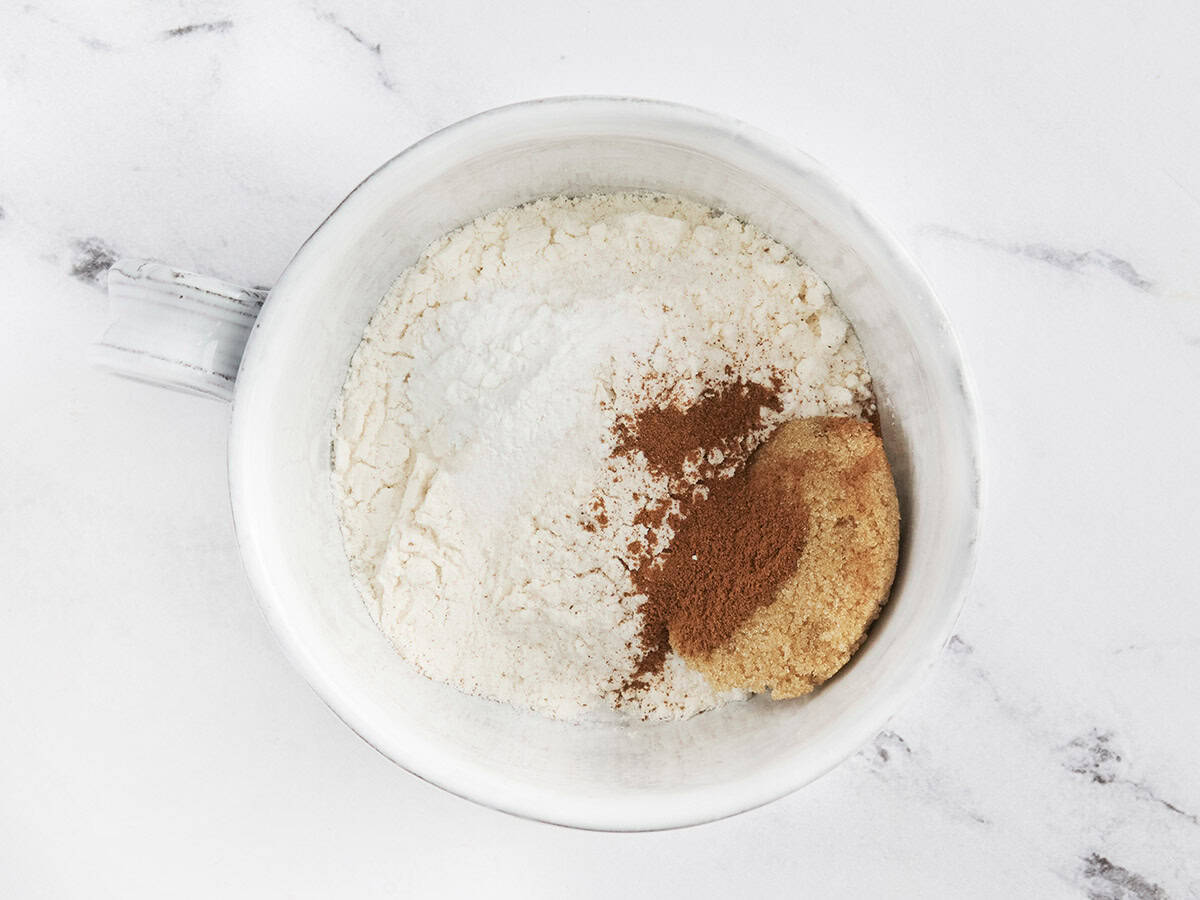 mixing dry ingredients together for blueberry mug muffin