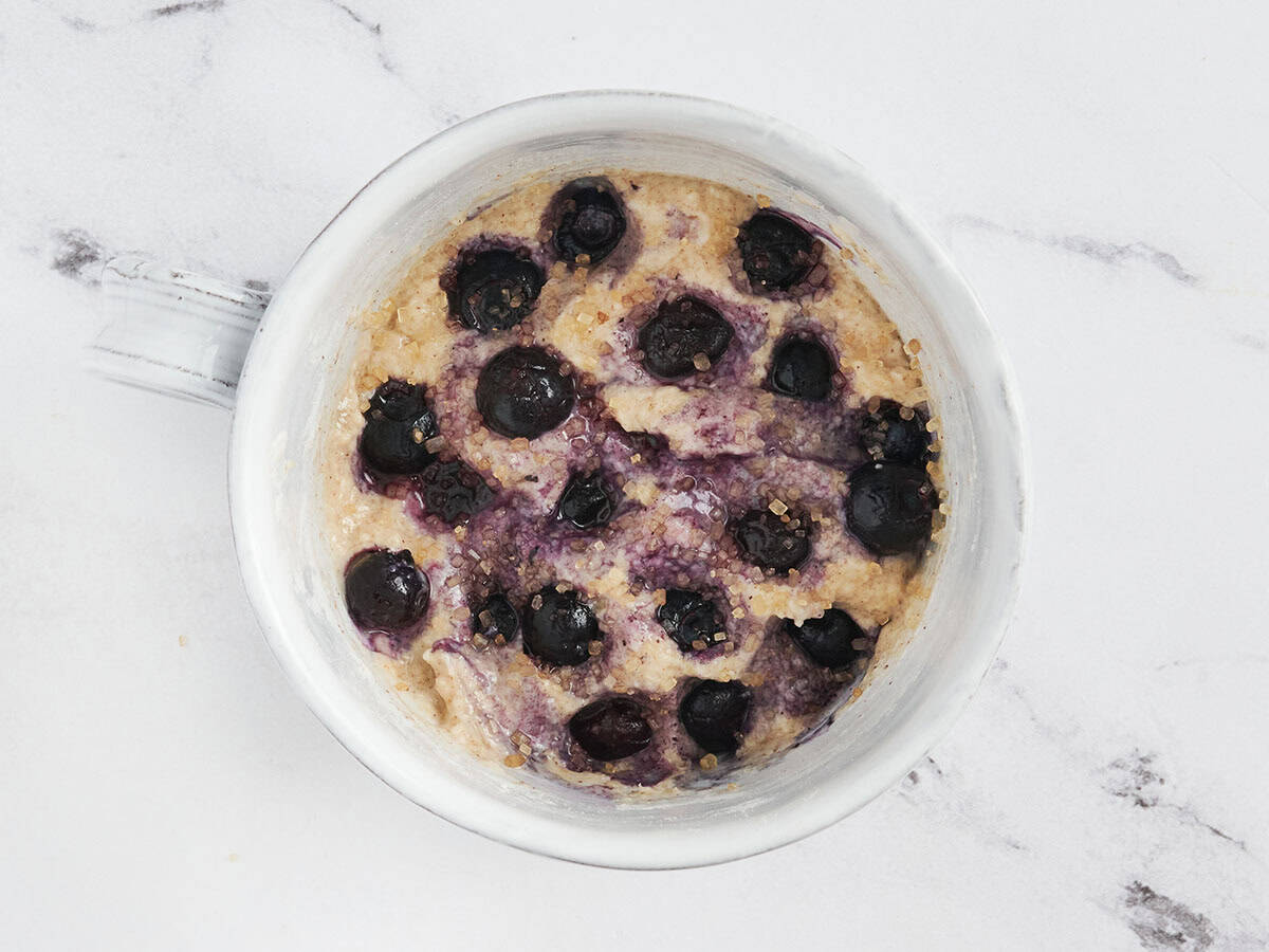 blueberries added on top of blueberry mug muffin