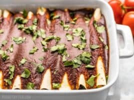 These hearty vegan Black Bean and Avocado Enchiladas are stuffed with fresh ingredients and drenched in a homemade sauce for big flavor in every bite. BudgetBytes.com