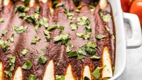 These hearty vegan Black Bean and Avocado Enchiladas are stuffed with fresh ingredients and drenched in a homemade sauce for big flavor in every bite. BudgetBytes.com