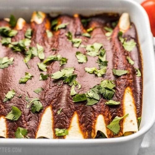 These hearty vegan Black Bean and Avocado Enchiladas are stuffed with fresh ingredients and drenched in a homemade sauce for big flavor in every bite. BudgetBytes.com