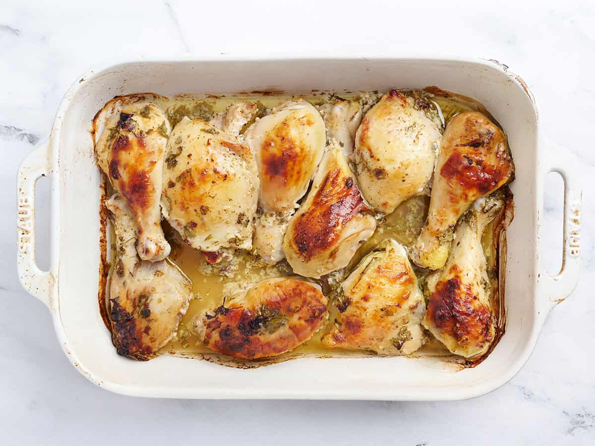 Freshly backed greek marinated chicken in a baking dish.