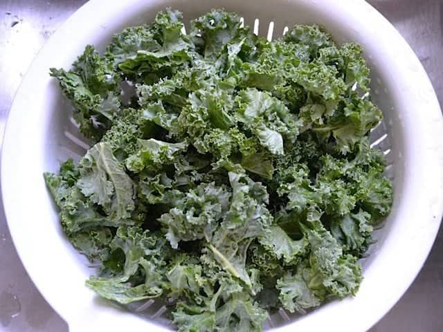 rinsing kale in colander 