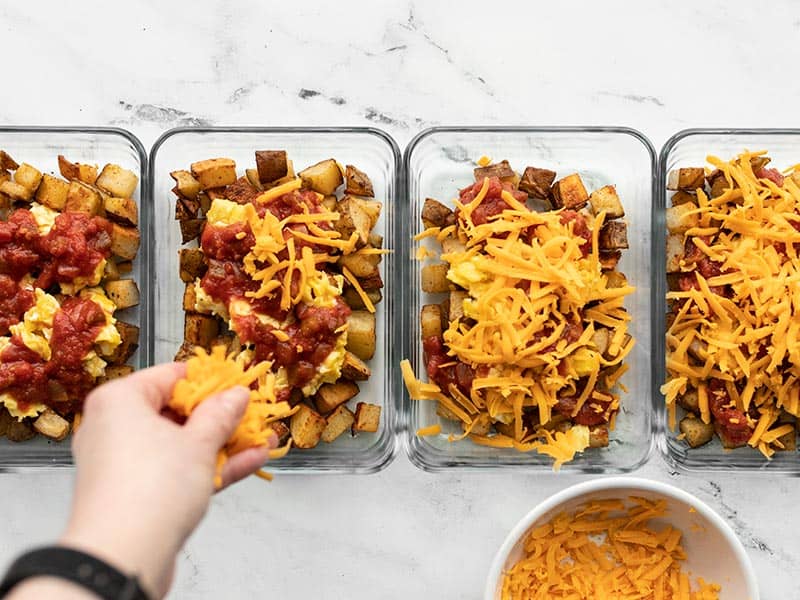 Add shredded cheddar to meal prep containers