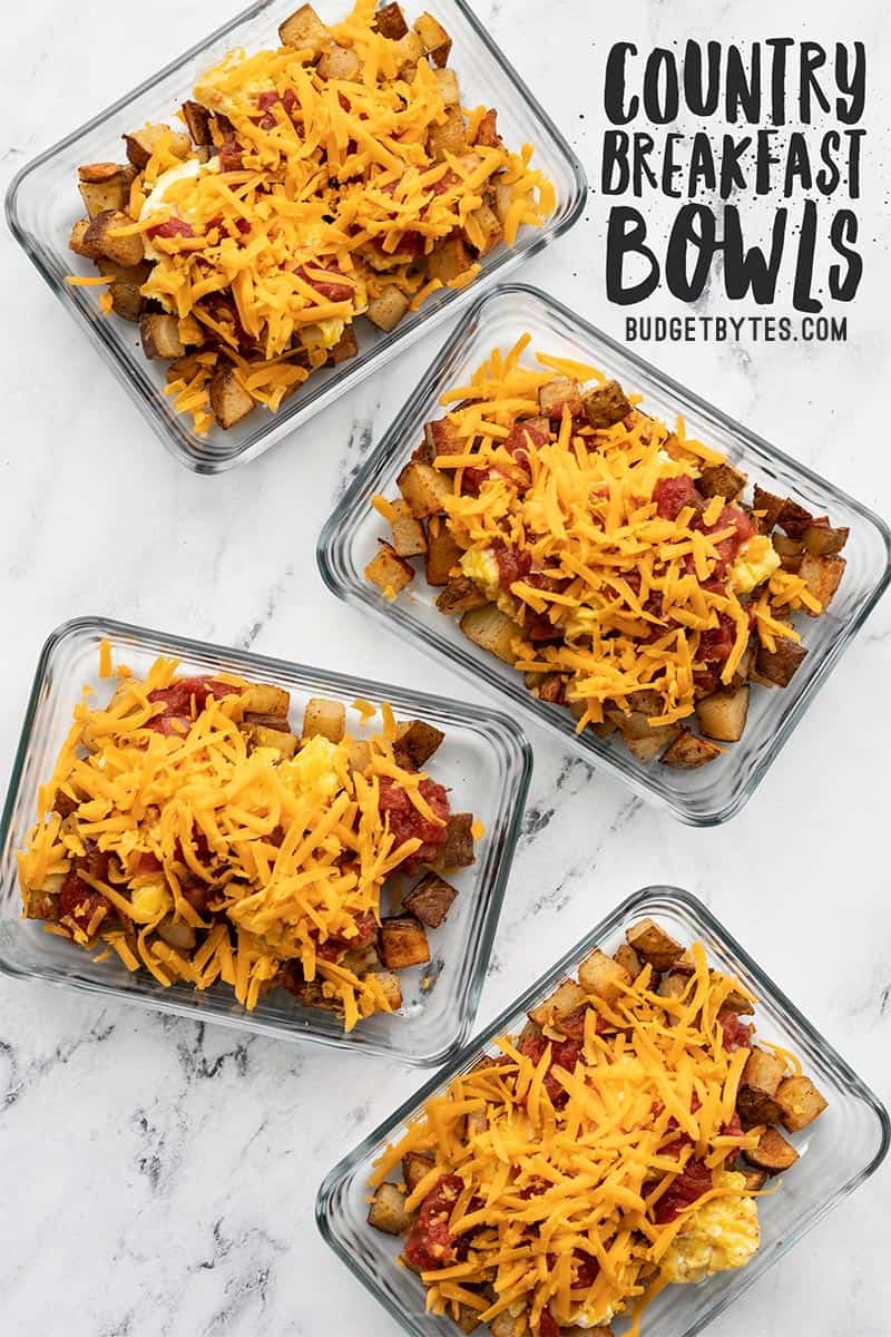 Four glass meal prep containers full of Country Breakfast Bowls