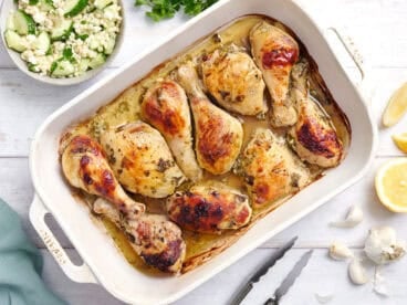 Overhead view of a pan of Greek marinated chicken.