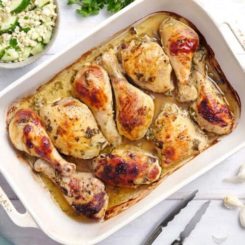 Overhead view of a pan of Greek marinated chicken.