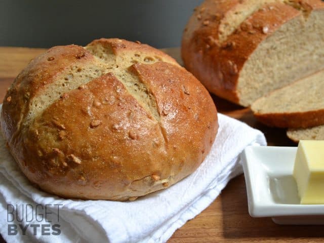 Loaf of Honey Sunflower Bread with a butter ramekin on the side 