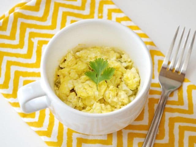 Top view of a Hummus Breakfast Mug with a fork on the side 