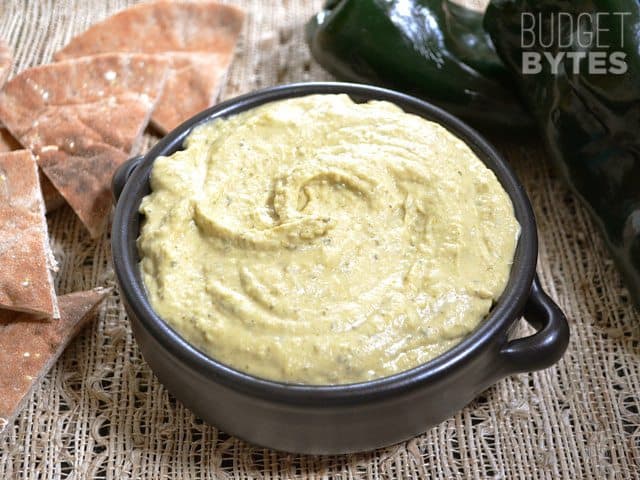 Bowl of Roasted Poblano Hummus with chips on the side 