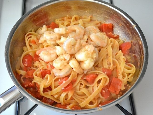 Shrimp added to skillet with pasta and sauce 