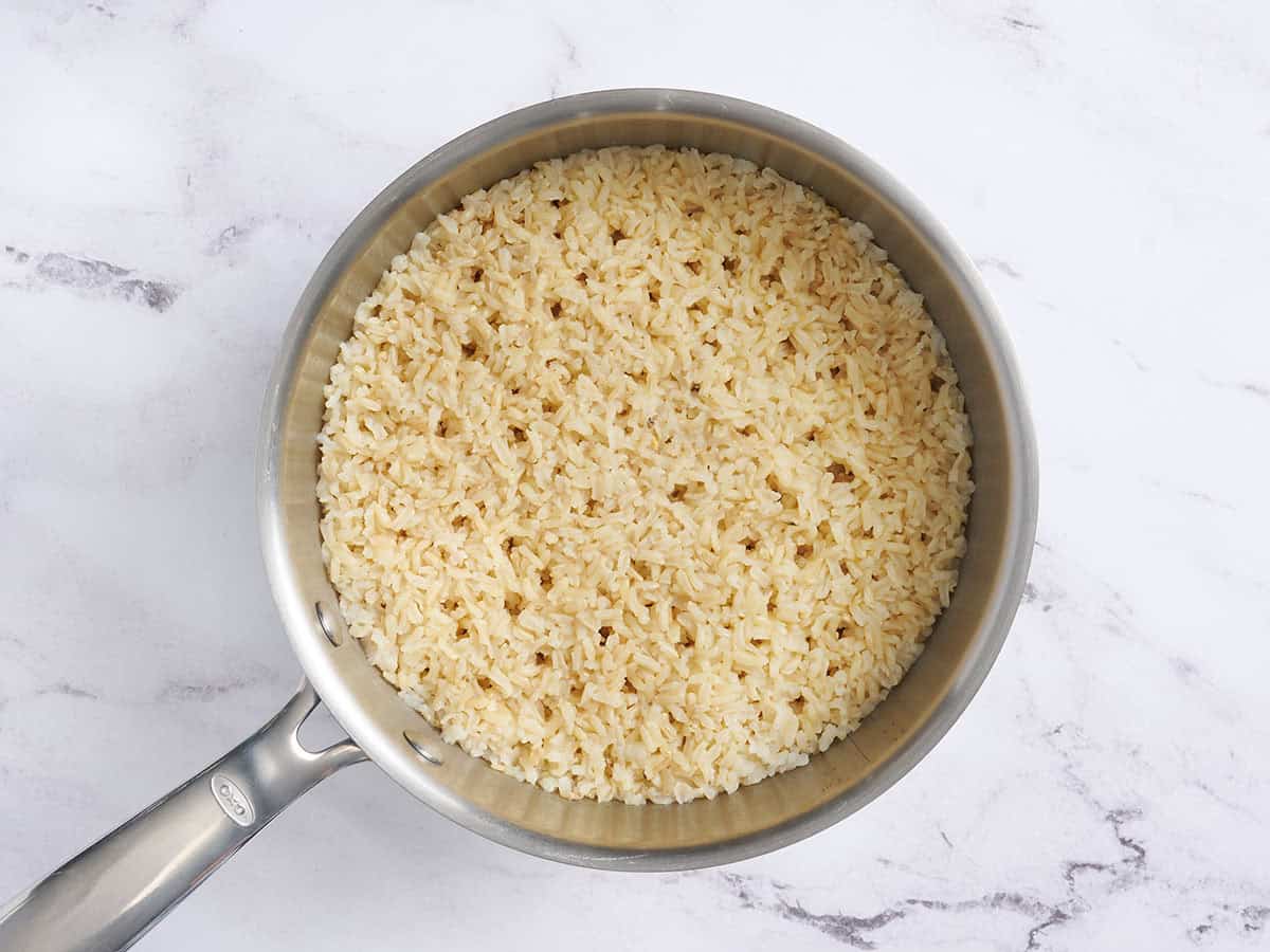 Brown rice cooking in a pan.