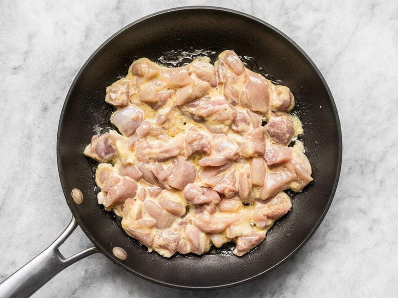 chicken being fried in the skillet