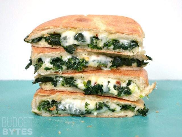 Four slices of Spinach Feta Grilled Cheese stacked on each other 