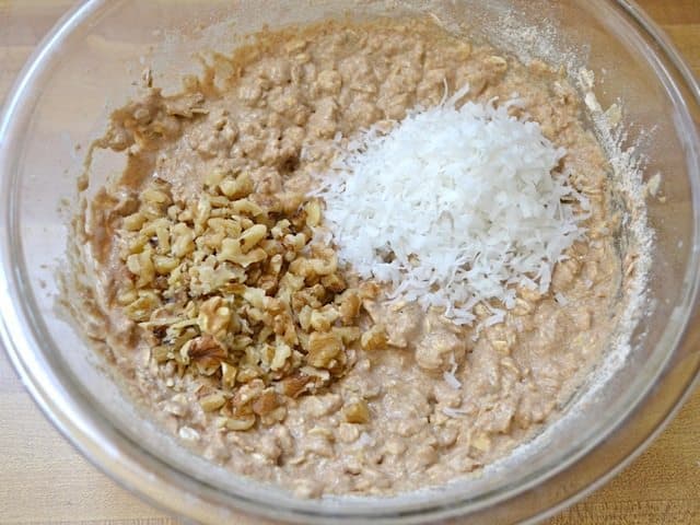 Chopped walnuts and shredded coconut added to mixing bowl 