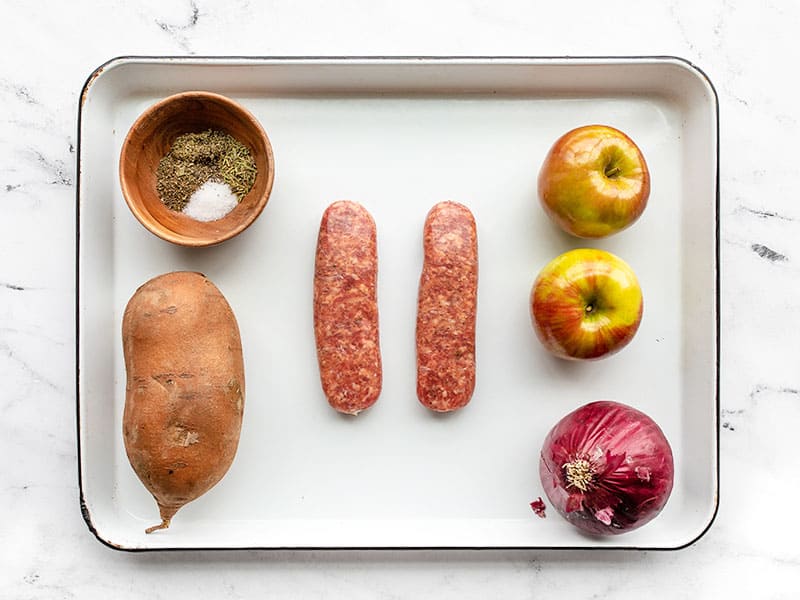 Oven roasted autumn medley ingredients on the sheet pan, whole