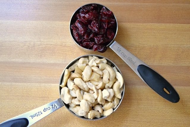 Cashews and Cranberries in measuring cups 