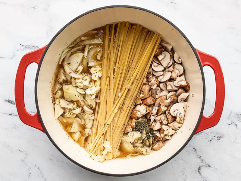 Ingredients pushed down in the pot below the broth