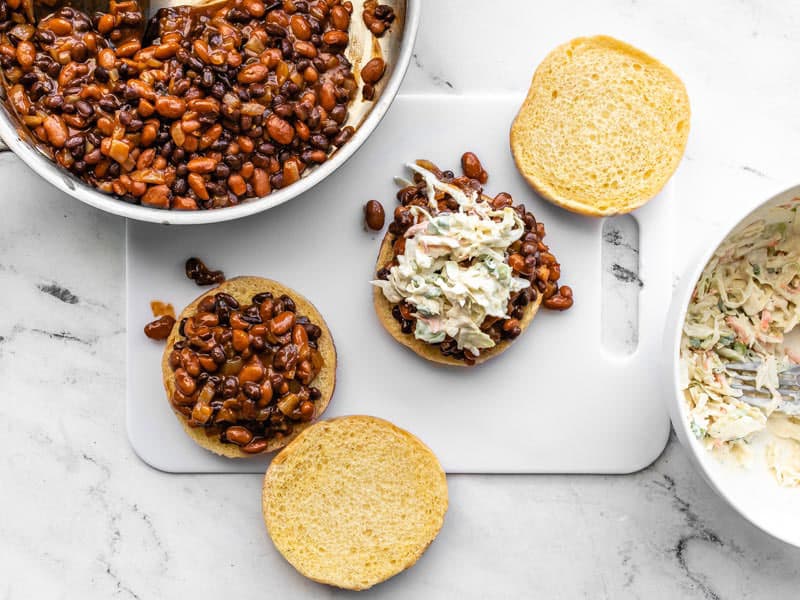 BBQ bean sliders being assembled on a cutting board