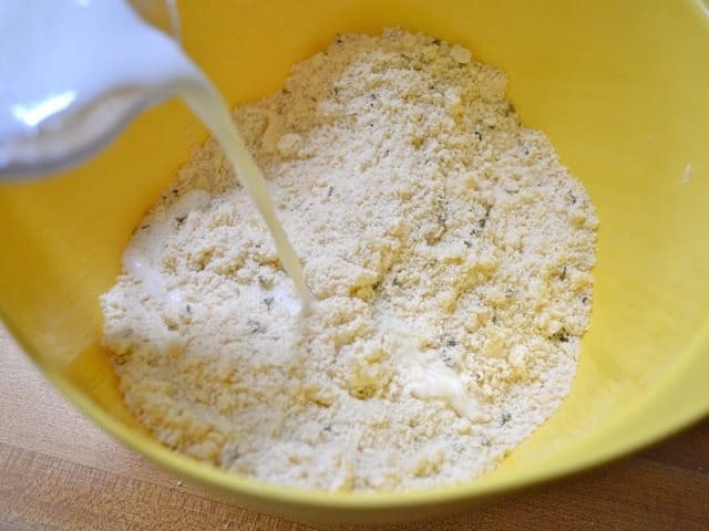 Milk added to dry ingredients in mixing bowl 