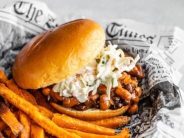 Side view of a BBQ Bean Slider on a plate with some sweet potato fries
