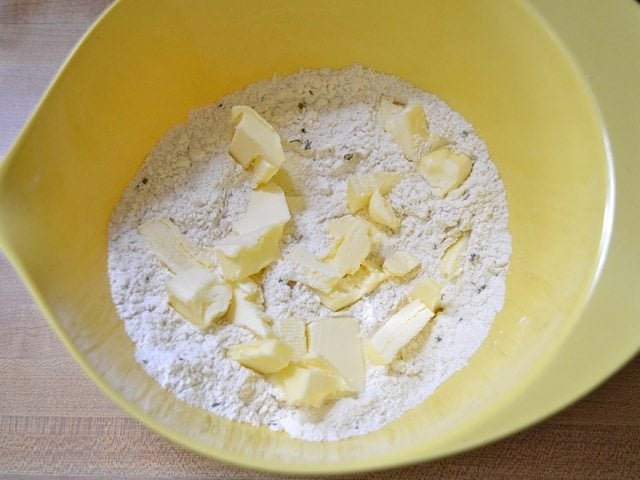 Butter added to dry ingredients in mixing bowl 