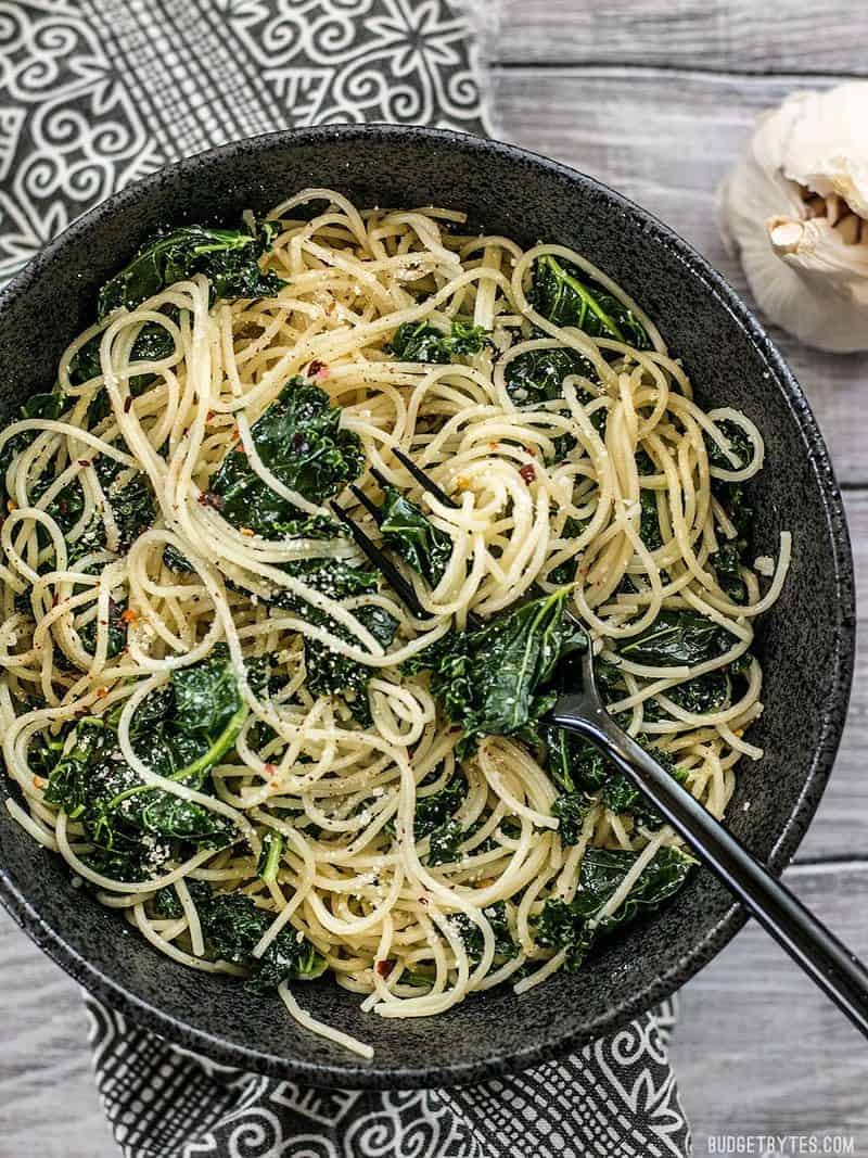 A huge bowl of Garlic Parmesan Kale Pasta with some twirled around a black fork.