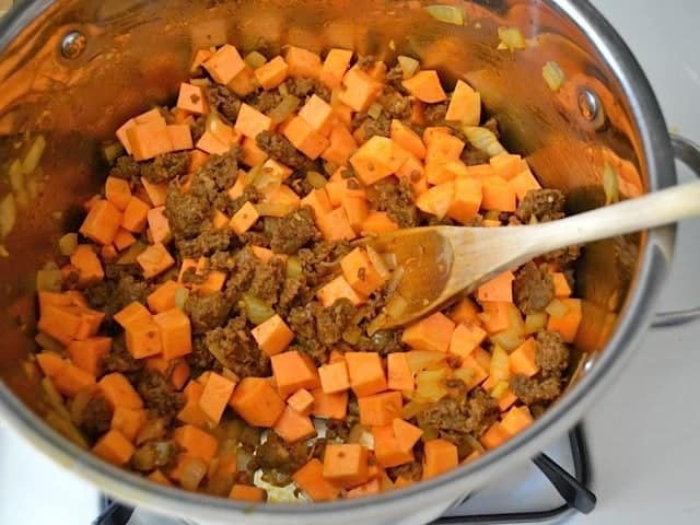 Diced Sweet Potatoes added to chorizo in pot 