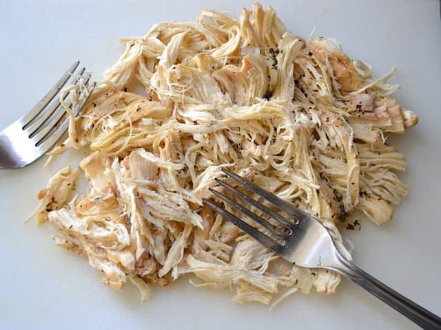Shredding chicken with two forks 