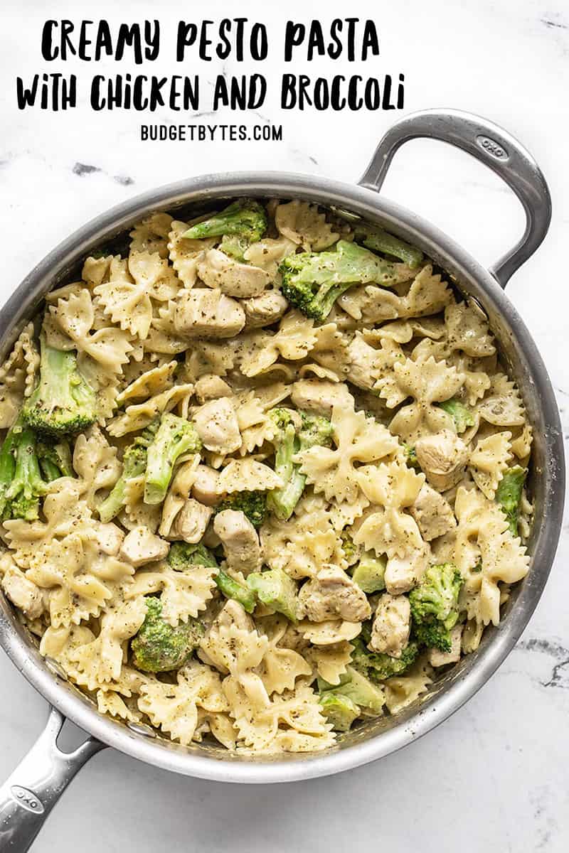 Overhead view of a skillet full of creamy pesto pasta with chicken and broccoli