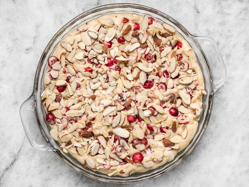 Cranberry Almond Cake batter in pie pan topped with sliced almonds 