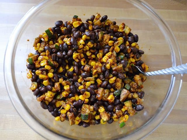 Roasted veggies put back in mixing bowl and black beans added 